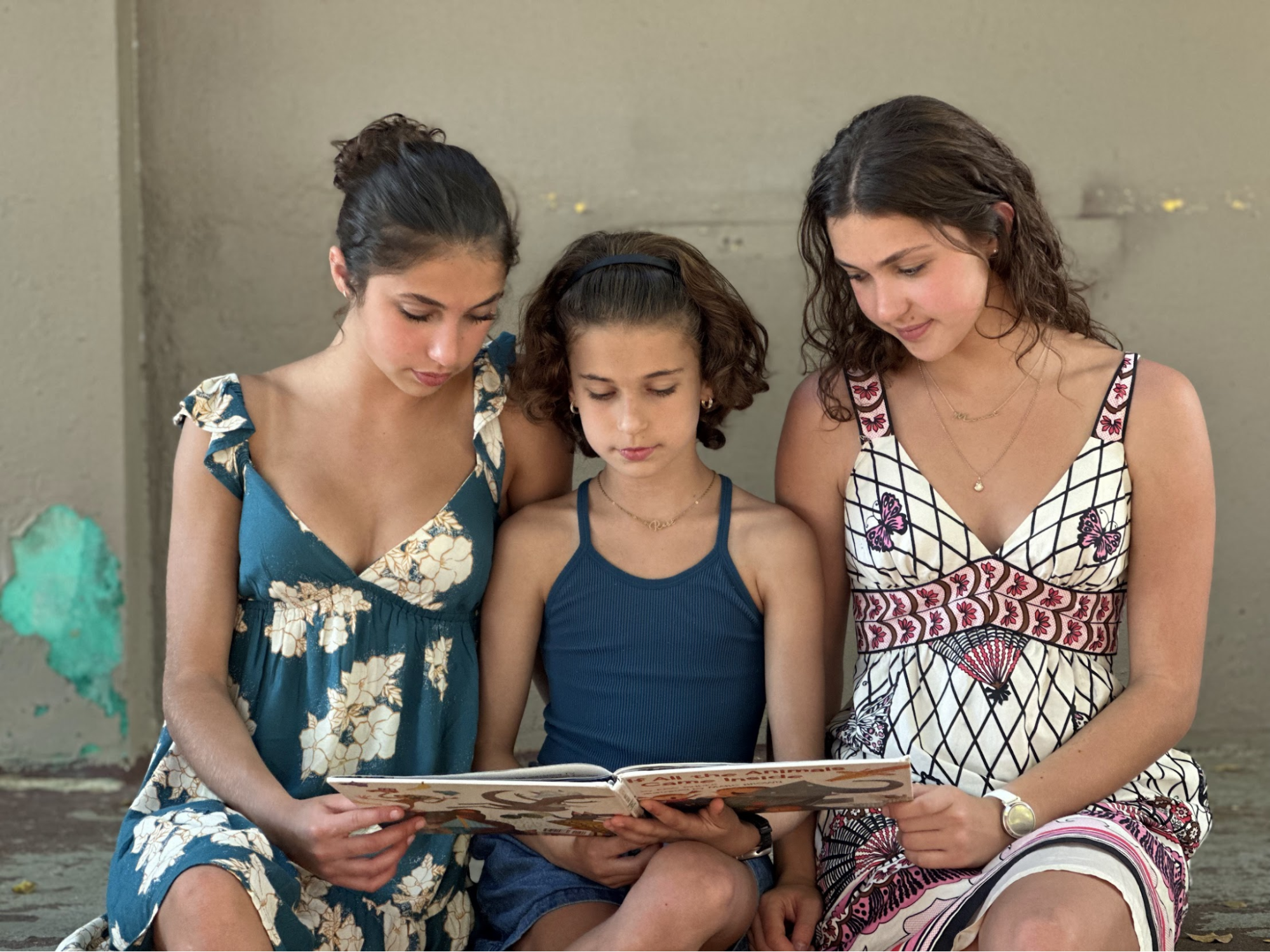 Three sisters reading